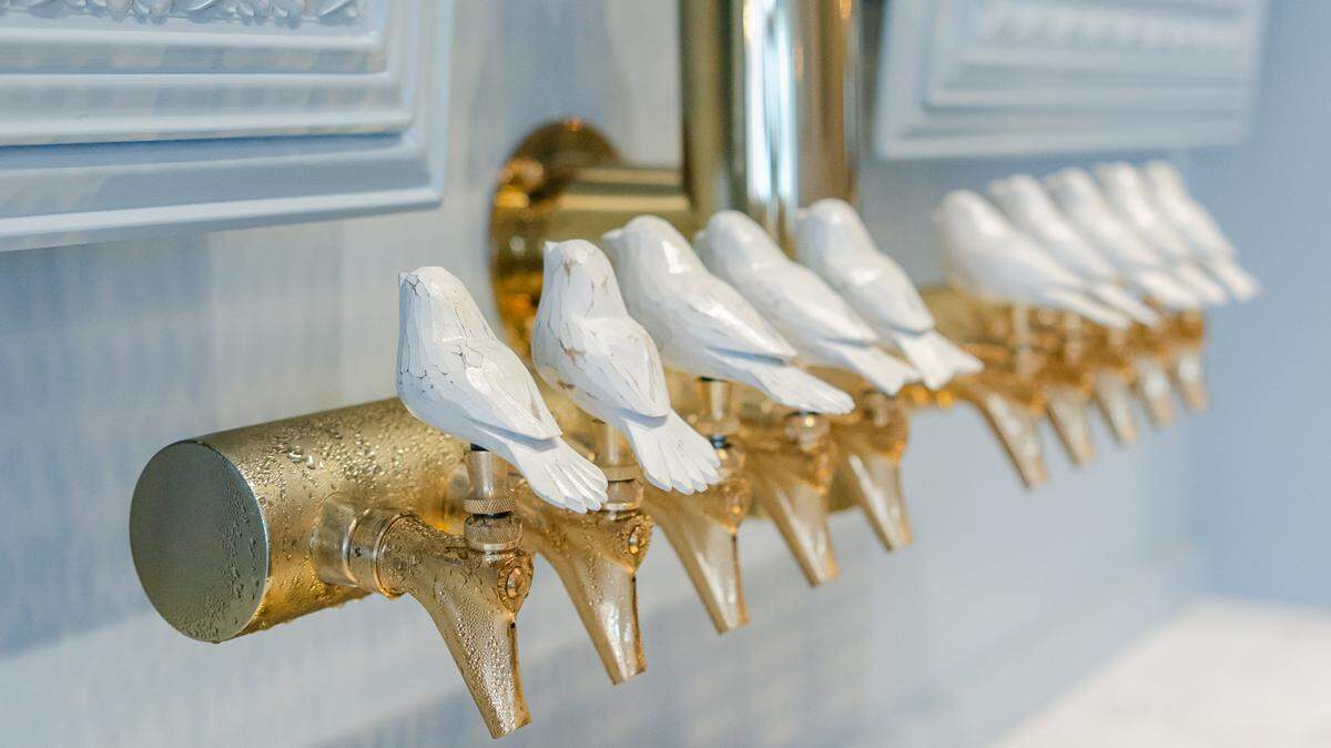 The King Canary Davidson Taproom includes these custom hand-whittled bird tap handles.