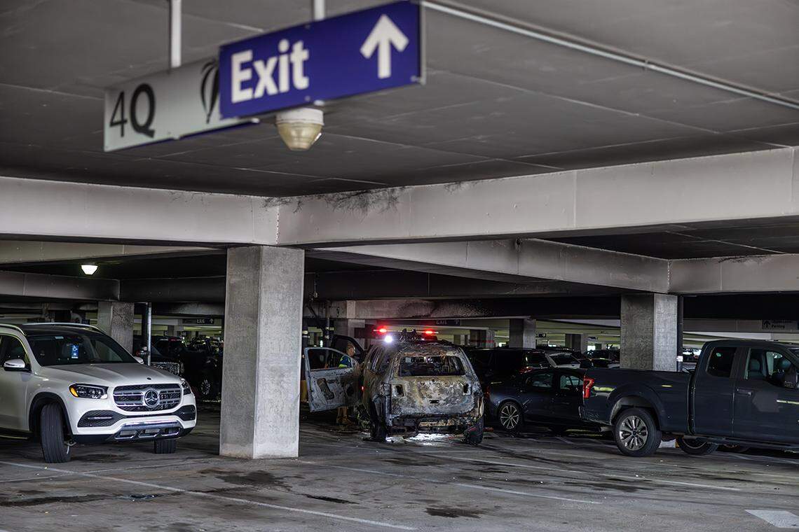 A damaged vehicle is being towed away from Charlotte Douglas International Airport parking deck Saturday morning, Aug. 10, 2024 were three people were injured in a two alarm fire.
