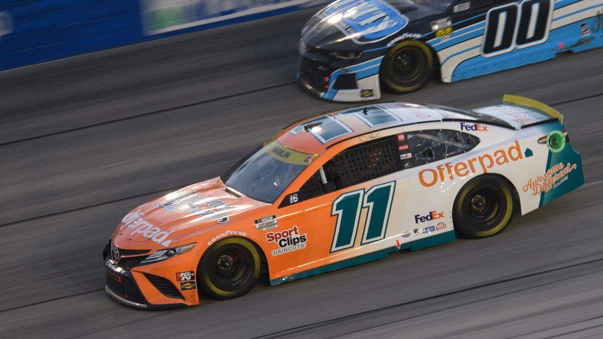 Denny Hamlin (11) races along with Quin Houff (00) in a NASCAR Cup Series auto race Sunday, Sept. 5, 2021, in Darlington, S.C. (AP Photo/John Amis)