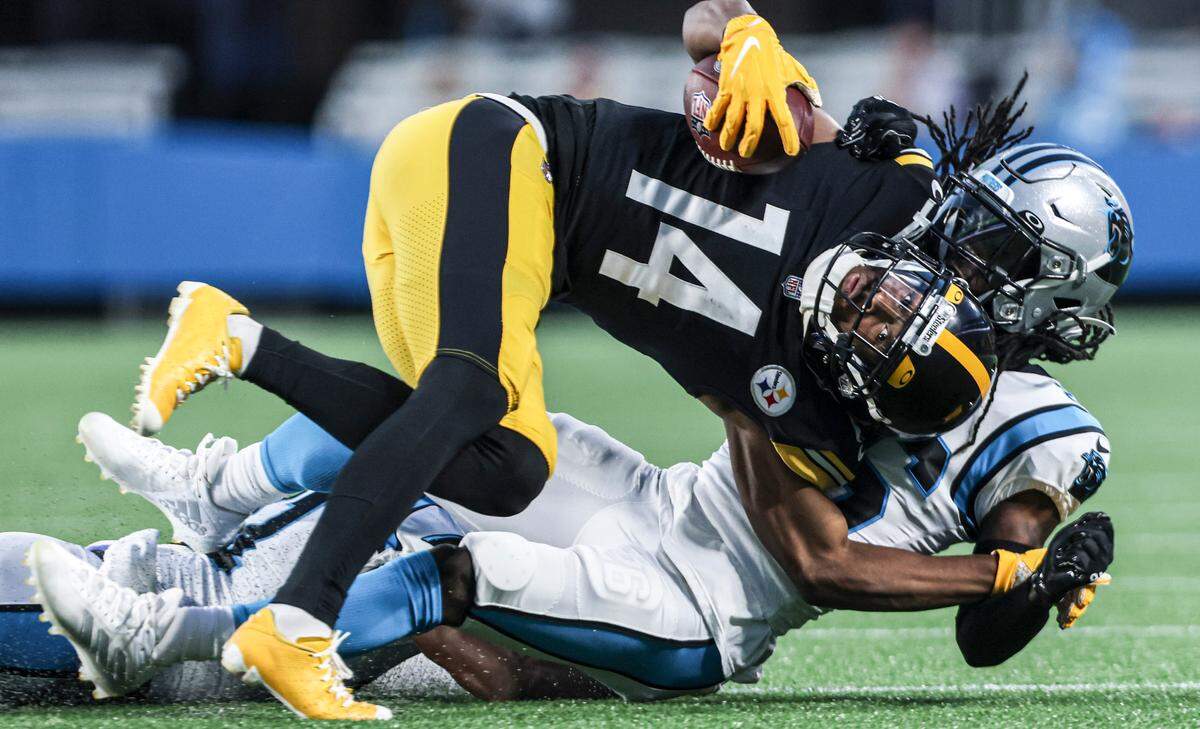 Pittsburgh Steelers Ray-Ray McCloud, top, is tackled by Carolina Panthers Donte Jackson at the Bank of America Stadium in Charlotte, N.C., on Friday, August 27, 2021.