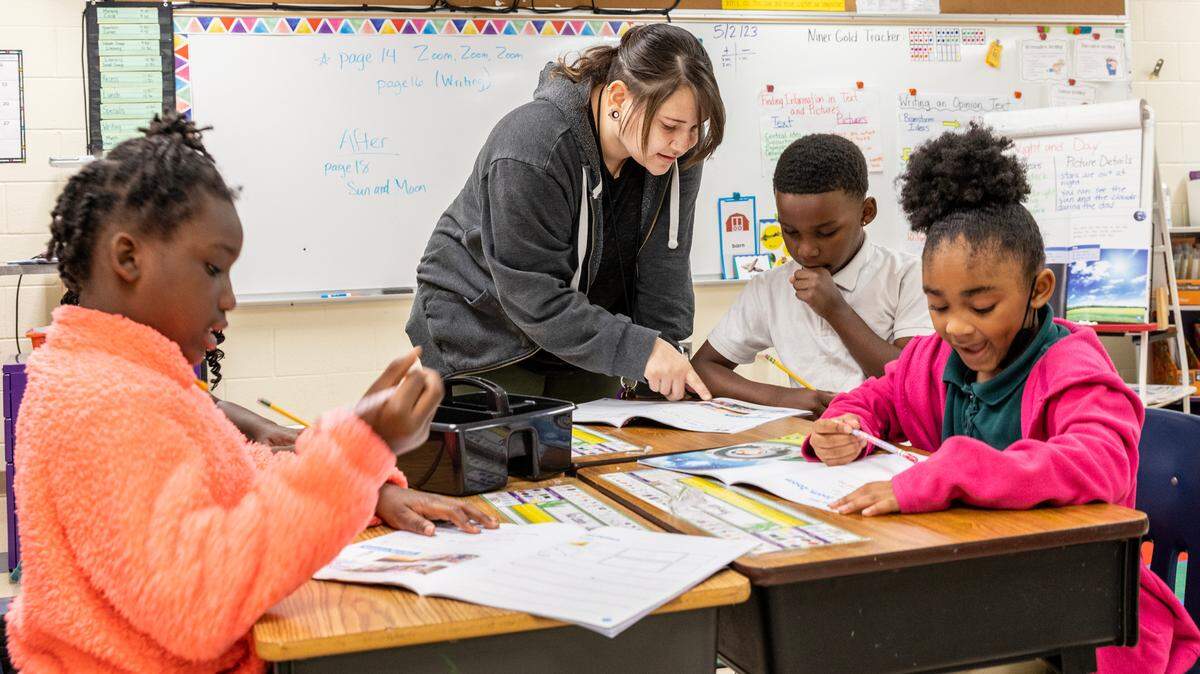 In this file photo, Jessica Caro, an arts teacher, works with students at Niner University Elementary, a lab school with the University of North Carolina Charlotte’s Cato College of Education. The school is now shutting down after Charlotte-Mecklenburg Schools said it wouldn’t renew its contract.
