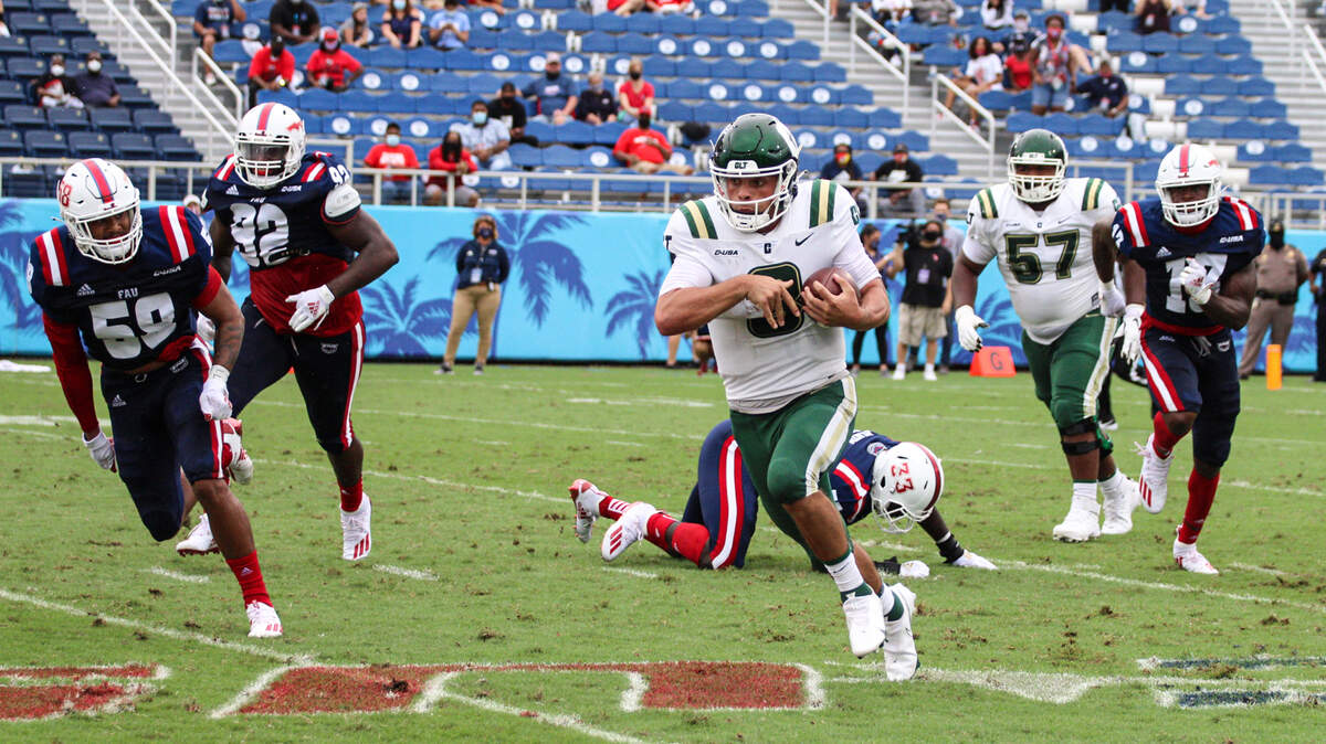 Charlotte 49ers quarterback Chris Reynolds picks up yardage against Florida Atlantic on Saturday. CHARLOTTE ATHLETICS