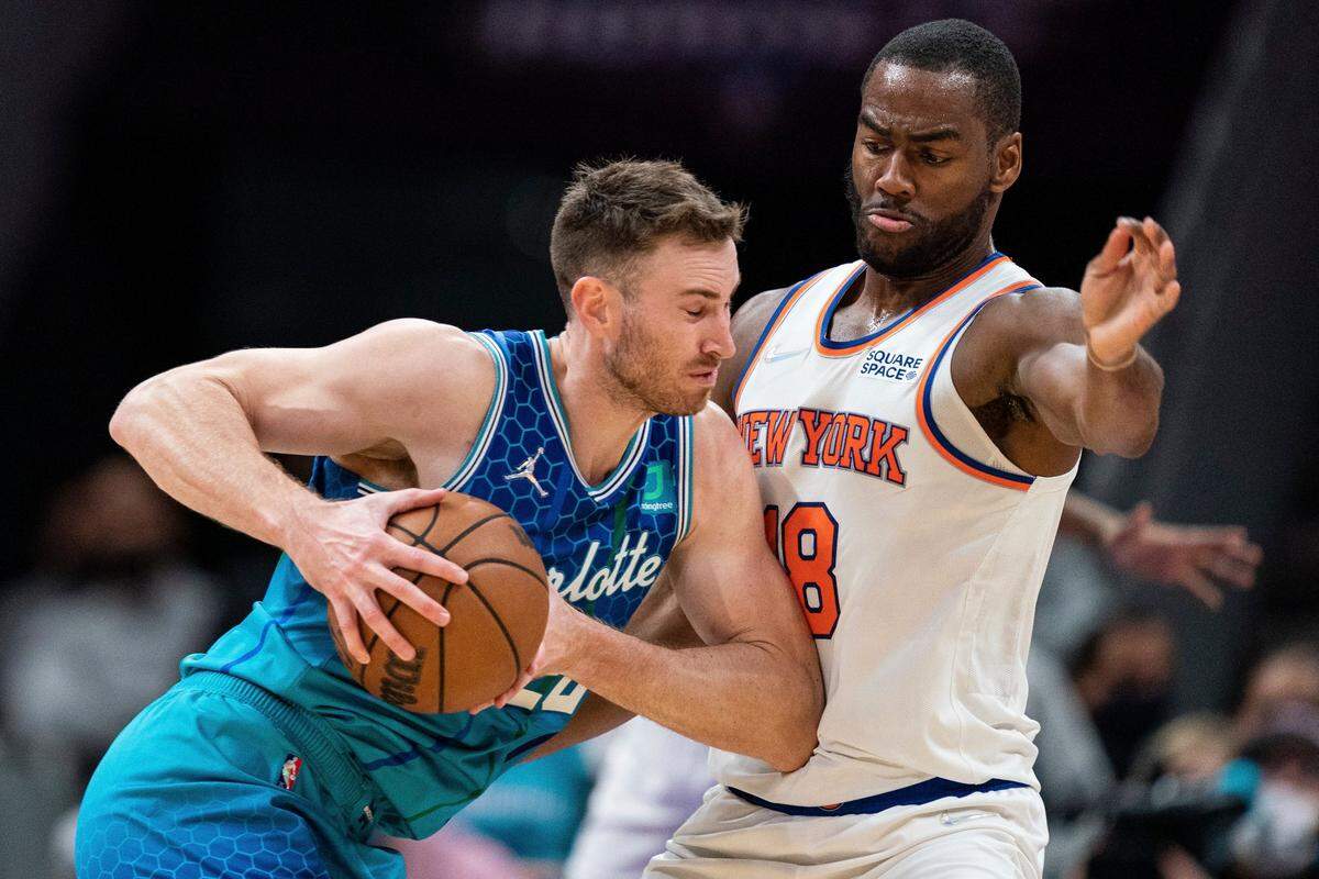 New York Knicks guard Alec Burks (18) guards Charlotte Hornets forward Gordon Hayward (20) during the second half of an NBA basketball game in Charlotte, N.C., Friday, Nov. 12, 2021. (AP Photo/Jacob Kupferman)
