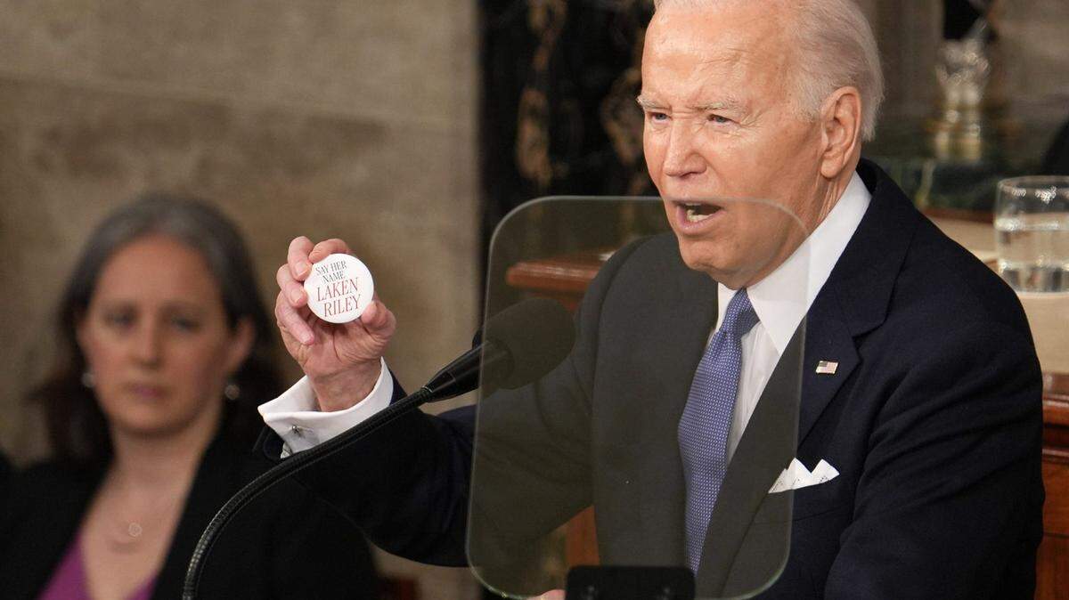 President Joe Biden delivers the State of the Union address to Congress at the U.S. Capitol in Washington on March 7, 2024. He is holding a button remembering the killing of 22-year-old Laken Riley, a nursing student whose body was found in a wooded area on the University of Georgia’s main campus in Athens, Ga.