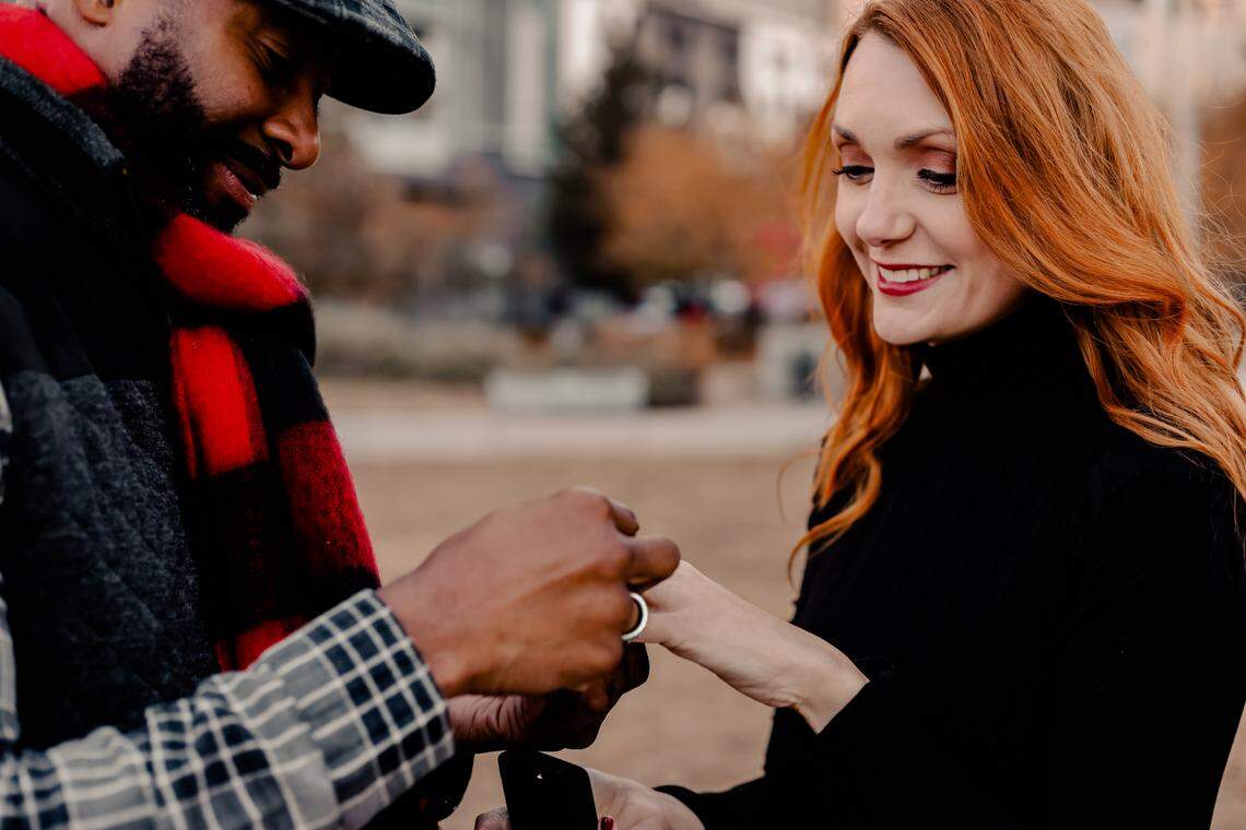 Fred slips an engagement ring onto Marley’s finger at Romare Bearden Park last November.