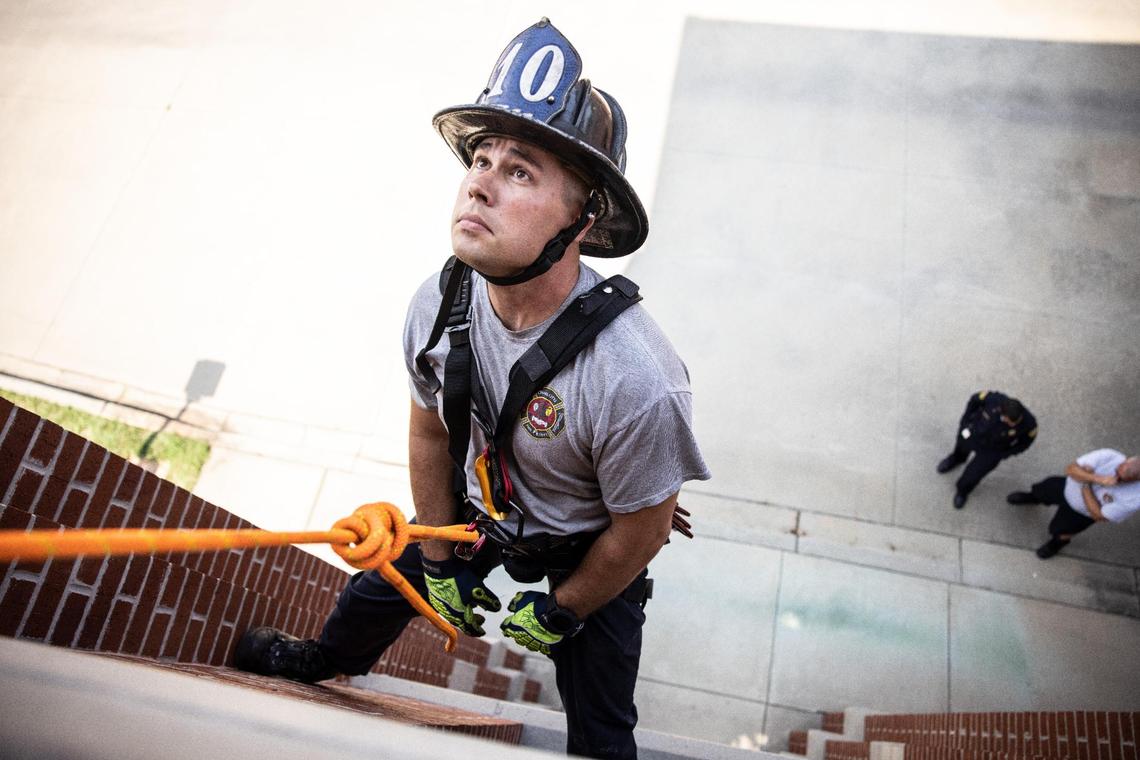 Bradley Blackmon waits to be rescued on the training tower while while demonstrating a high angle rescue at Fire Station 10 in Charlotte, on Wednesday, July 21, 2021.