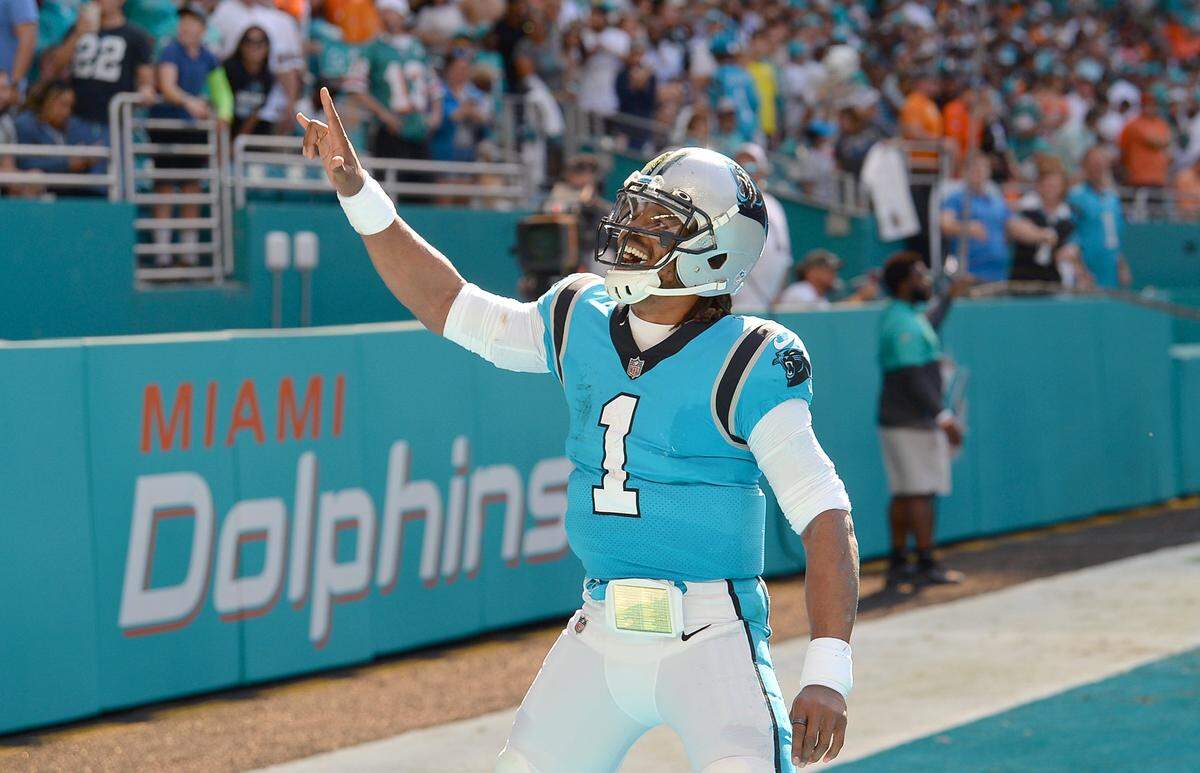 Carolina Panthers quarterback Cam Newton celebrates his rushing touchdown against the Miami Dolphins during first quarter action at Hard Rock Stadium in Miami Gardens, Fla. on Sunday, November 28, 2021.