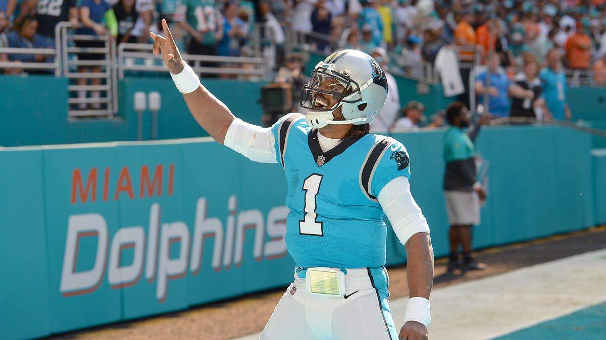 Carolina Panthers quarterback Cam Newton celebrates his rushing touchdown against the Miami Dolphins during first quarter action at Hard Rock Stadium in Miami Gardens, Fla. on Sunday, November 28, 2021.