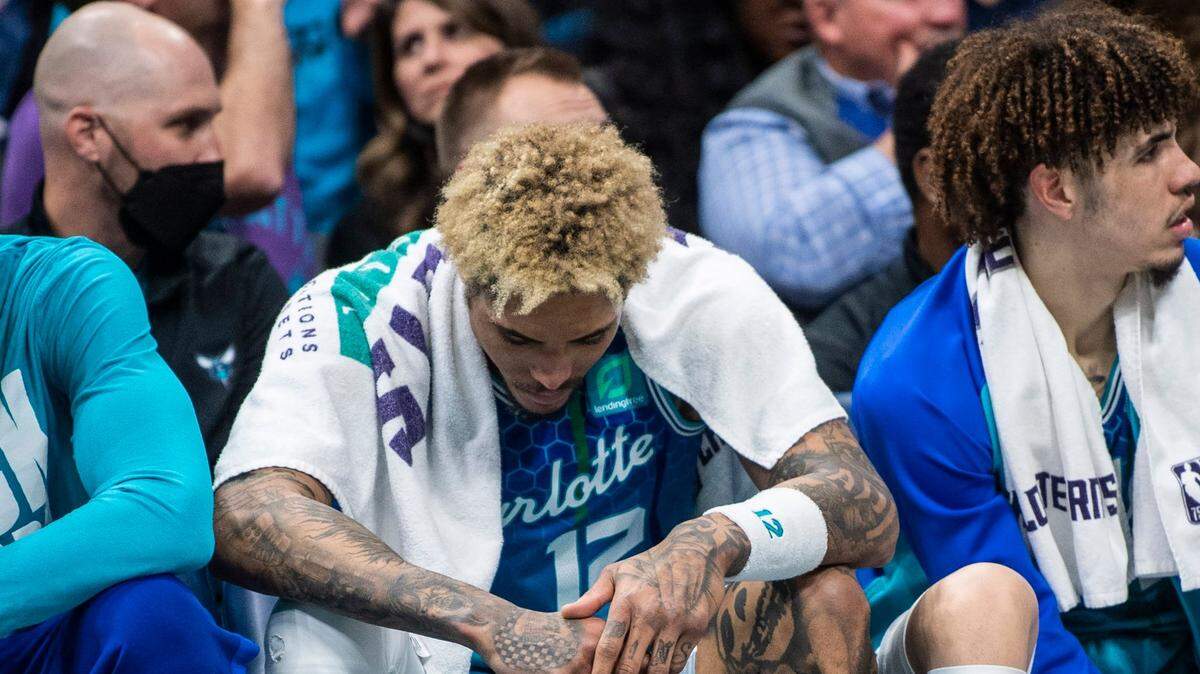 The Hornets guard Kelly Oubre, Jr., left, hangs his head on the bench during the game against the Grizzzlies at Spectrum Center on Saturday, February 12, 2022 in Charlotte, NC. The Hornets lost to the Grizzlies, 125-118, making the sixth consecutive loss at home.