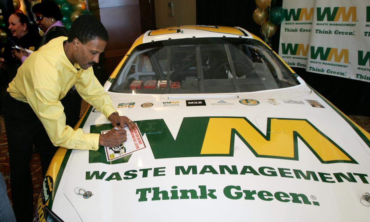Bill Lester signs a autograph Tuesday, March 14, 2006, in Atlanta, after a news conference held to announce he will be the driver for the new No. 23 Waste Management Dodge. Lester will attempt to become the first black driver in nearly 20 years to qualify for a race in NASCAR’s top series. He’s a longshot to make the 43-car field for the Nextel Cup race at Atlanta Motor Speedway, but hopes that his presence will inspire others to follow. (AP Photo/John Amis)