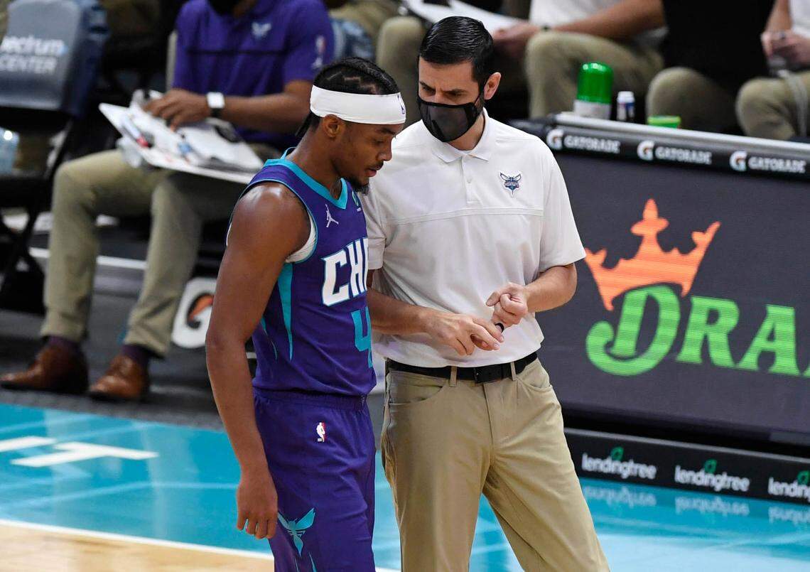 Charlotte Hornets guard Devonte’ Graham (4) talks with head coach James Borrego during a time out against the Indiana Pacers during the first half of their game at the Spectrum Center on Wednesday, January 27, 2021.