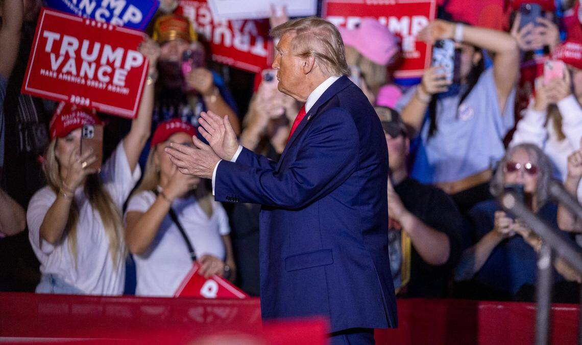 Former President Donald Trump takes the stage during a rally at Minges Coliseum in Greenville on Monday, Oct. 21, 2024.