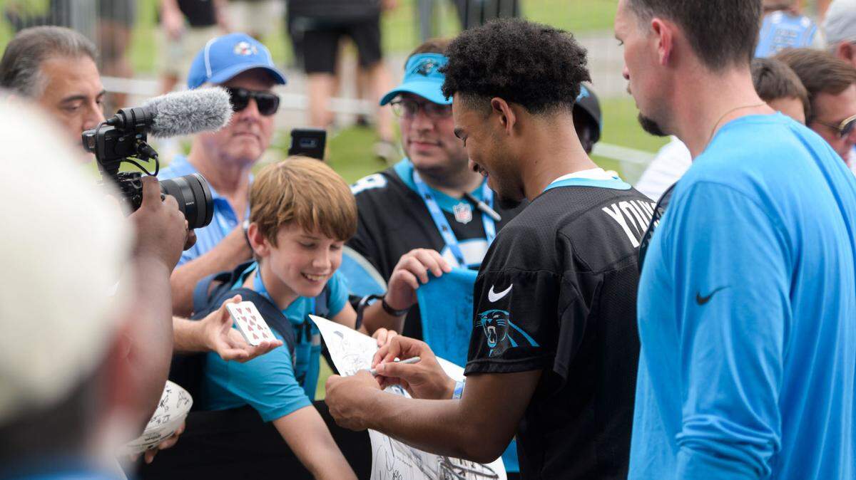 Carolina Panthers quarterback, Bryce Young, signs autographs with fans after a Training Camp practice on Saturday, July 29, 2023.