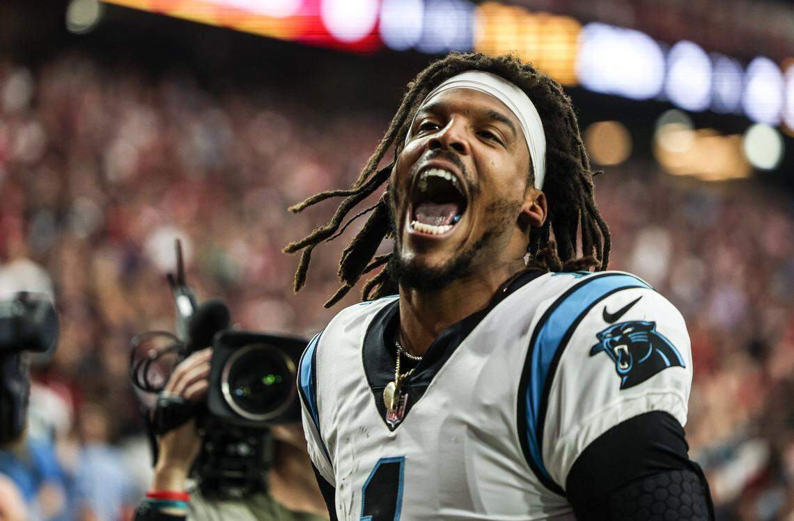 Carolina Panther QB Cam Newton celebrates after scoring on a 2-yard run against Arizona Sunday on his first play of the game.