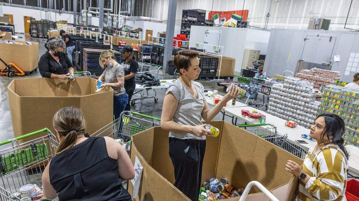 Volunteers from Elevation Church and Sephora sort canned food at Loaves & Fishes and Friendship Trays in Charlotte on Wednesday, June 8, 2022.