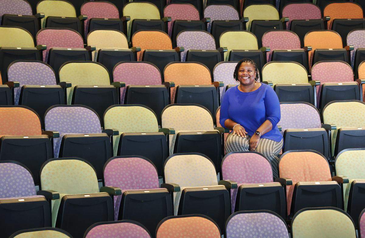 Lakeetha Blakeney, who wrote the play “Bessie Coleman: Fearless and Free," sits in an auditorium at ImaginOn in Charlotte.