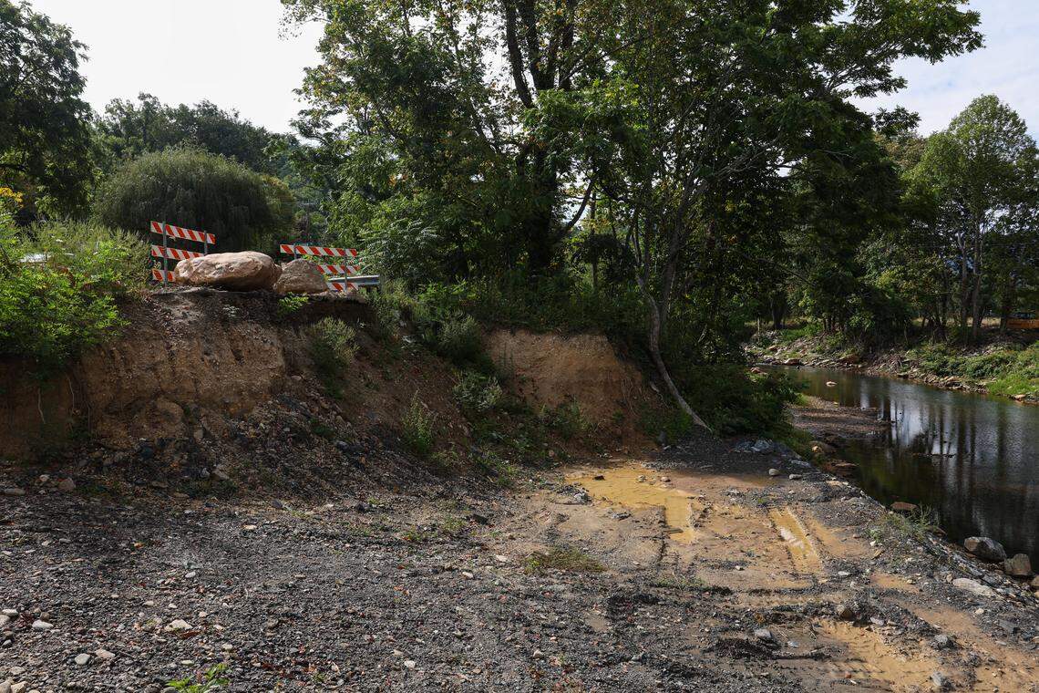 A damaged road sits unrepaired beside Cattail Creek near Pensacola, N.C., in September.