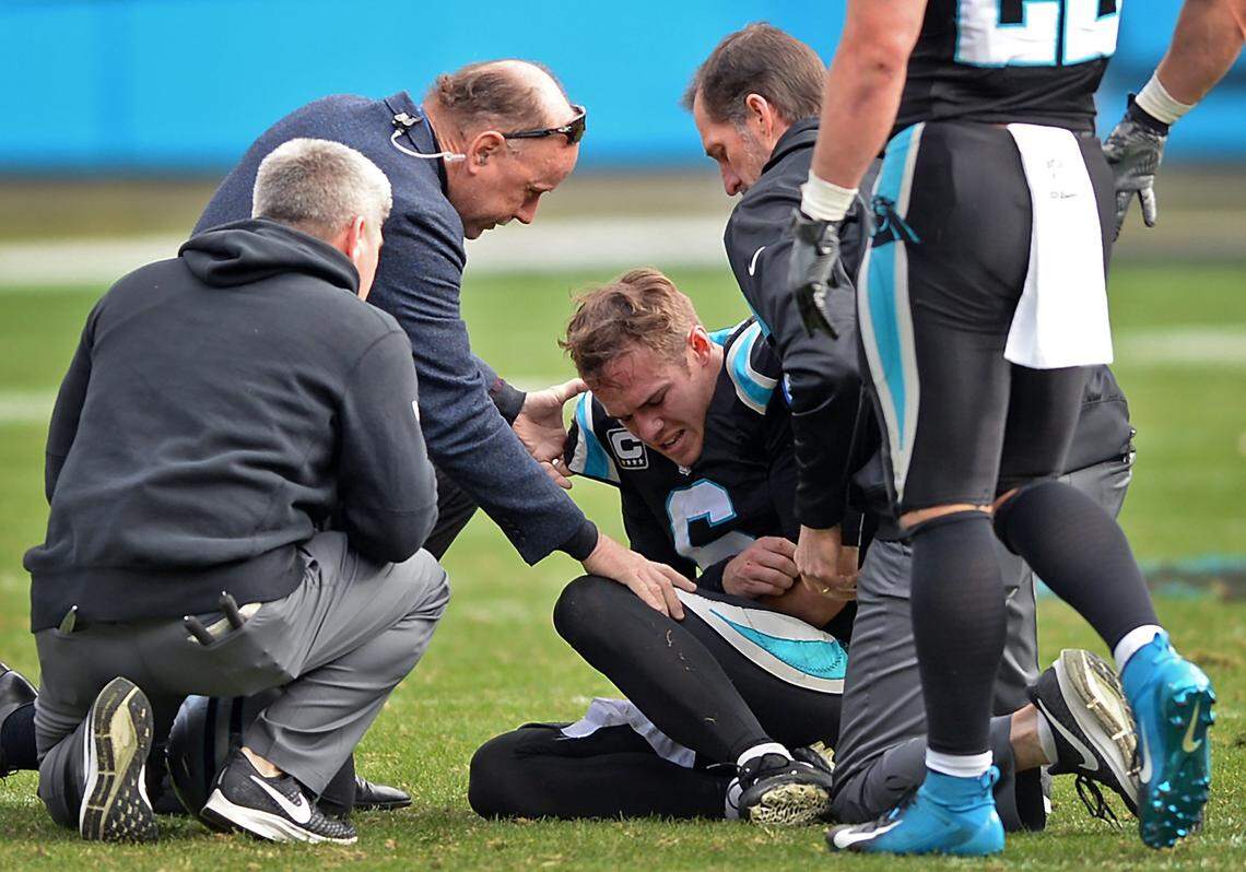 Carolina Panthers quarterback Taylor Heinicke holds his left arm as he is attended to by team physicians. Heinicke was tackled by Atlanta Falcons defensive tackle Grady Jarrett during second quarter action at Bank of America Stadium in Charlotte, NC on Sunday, December 23, 2018. The Falcons defeated the Panthers 24-10.