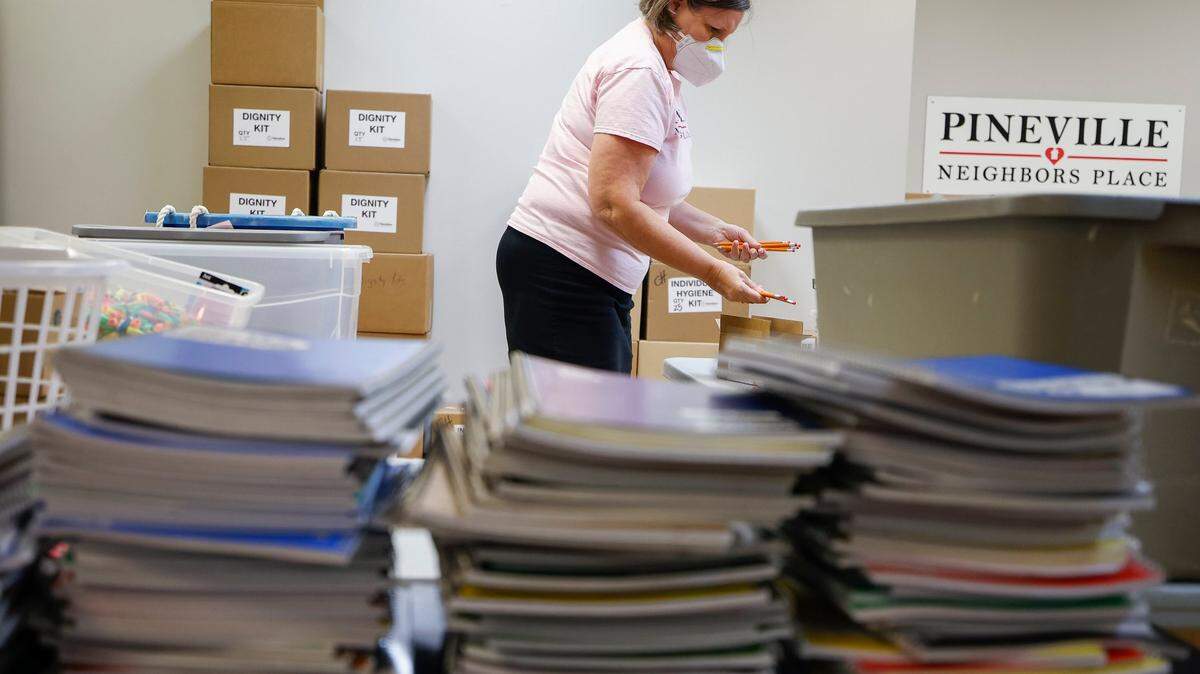 Jane Shutt, of Pineville, N.C., executive director of Pineville Neighbors Place, organizes school supplies, Tuesday, Aug. 9, 2022. Pineville Neighbors Place provides school supplies, food and other essentials for people affected by poverty in the Pineville area.