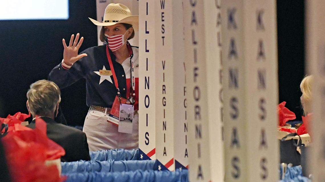 A Republican National Convention delegate waves to other delegates prior to the start of the convention in the Richardson Ballroom.