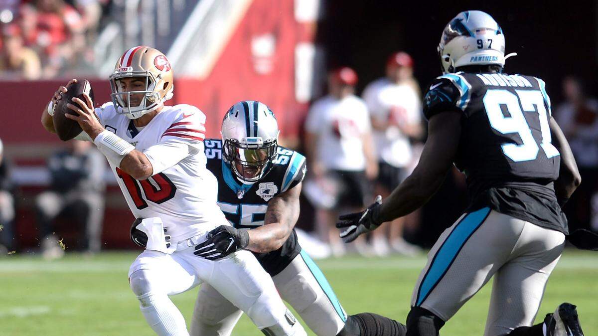 San Francisco 49ers quarterback Jimmy Garoppolo, left, is sacked by Carolina Panthers defensive end Bruce Irvin, center, during third quarter action at Levi’s Stadium in Santa Clara, CA on Sunday, October 27, 2019.The 49ers defeated the Panthers 51-13.