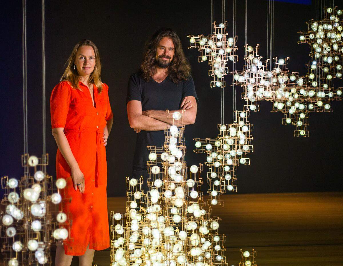 Lonneke Gordijn, left, and Ralph Nauta stand by their piece called “Fragile Futures,” at the Mint Museum Uptown in Charlotte on Thursday September 19, 2019. Studio Drift is a collection of five works by the two creators to explore the connection and boundaries of nature and technology.