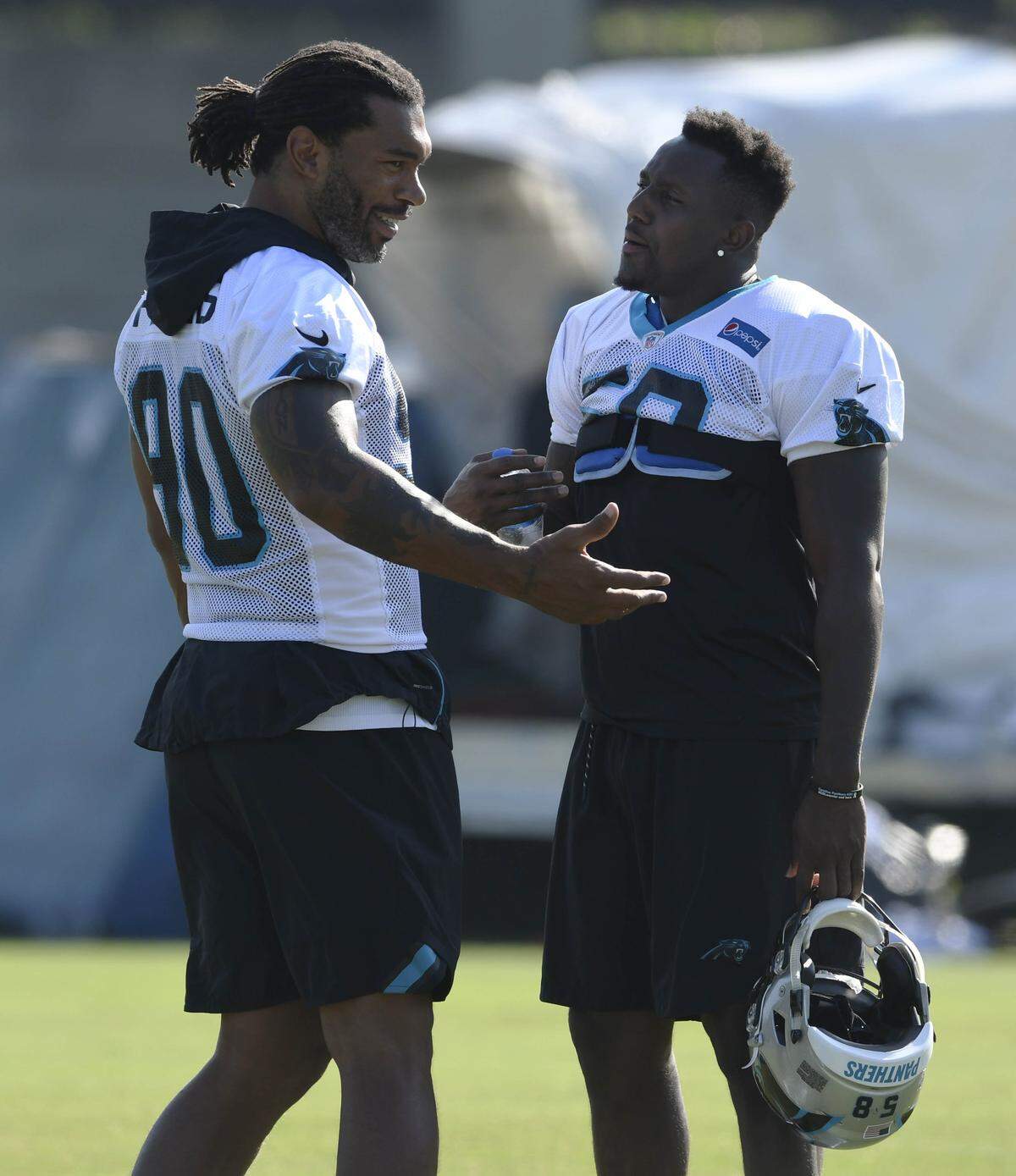 Carolina Panthers defensive end Julius Peppers (90) and linebacker Thomas Davis (58) are two of the team’s veterans who have specific workout plans that factor in many details, including their ages and former injuries.