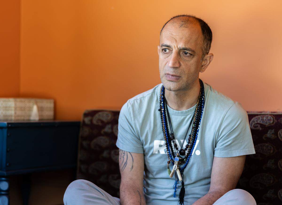 Amir Behdani, an Iranian immigrant, becomes emotional as he speaks about the war with Iran in Charlotte, N.C., on Tuesday, April 7, 2026. 