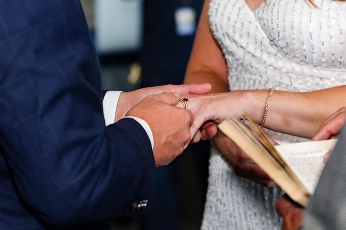 Elizabeth Evers and Adam Johnson exchanged wedding vows in the Atrium of Charlotte Douglas International Airport on Friday, Sept. 9, 2022.