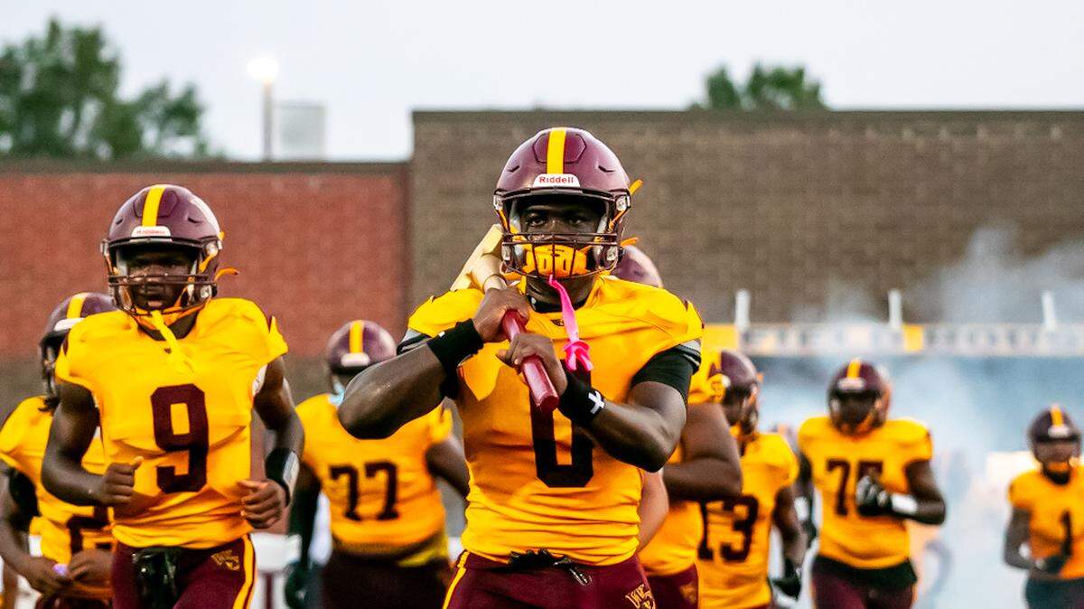 West Charlotte players run onto the field for their home game with Monroe on Friday. Due to new school construction, the Lions hadn’t had a home game in four years.