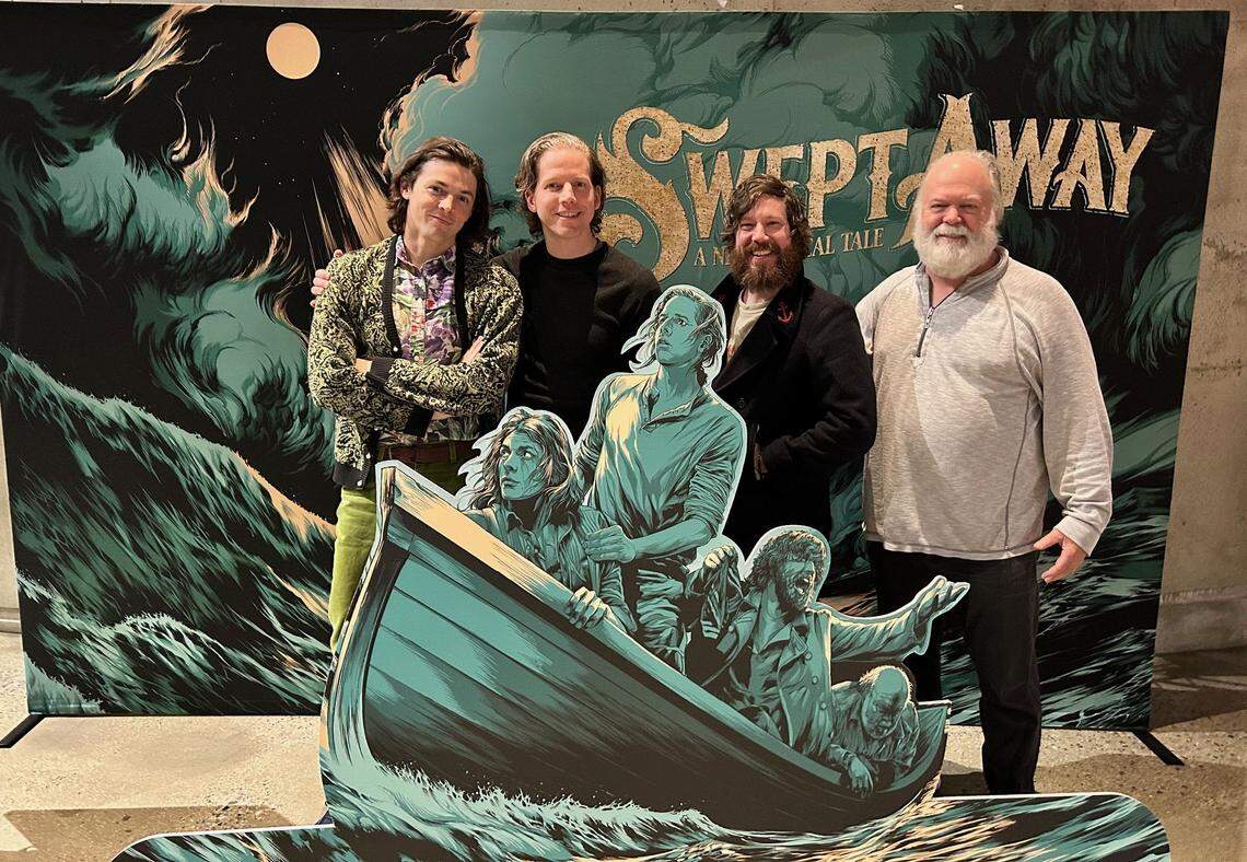 The stars of “Swept Away” stand behind their characters in this Arena Stage lobby cut-out poster. From left, Adrian Blake Enscoe, Stark Sands, John Gallagher Jr. and Wayne Duvall.