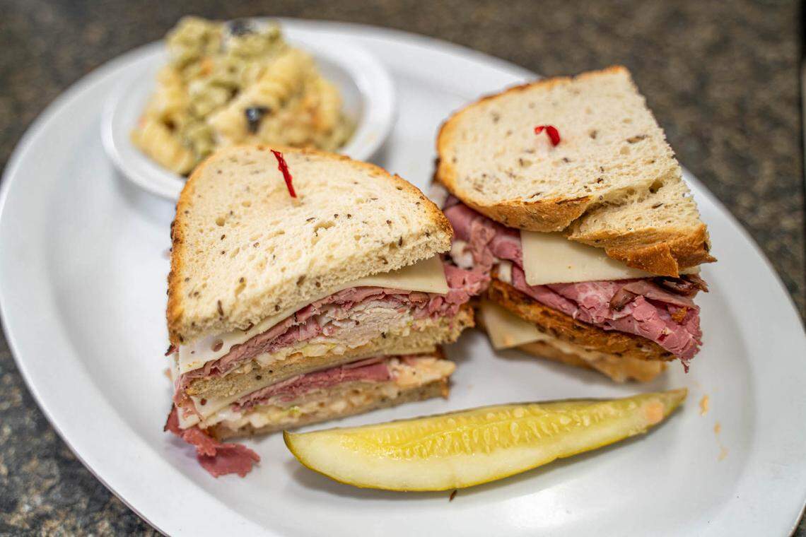 A Triple Decker Reuben on rye bread with pasta salad.