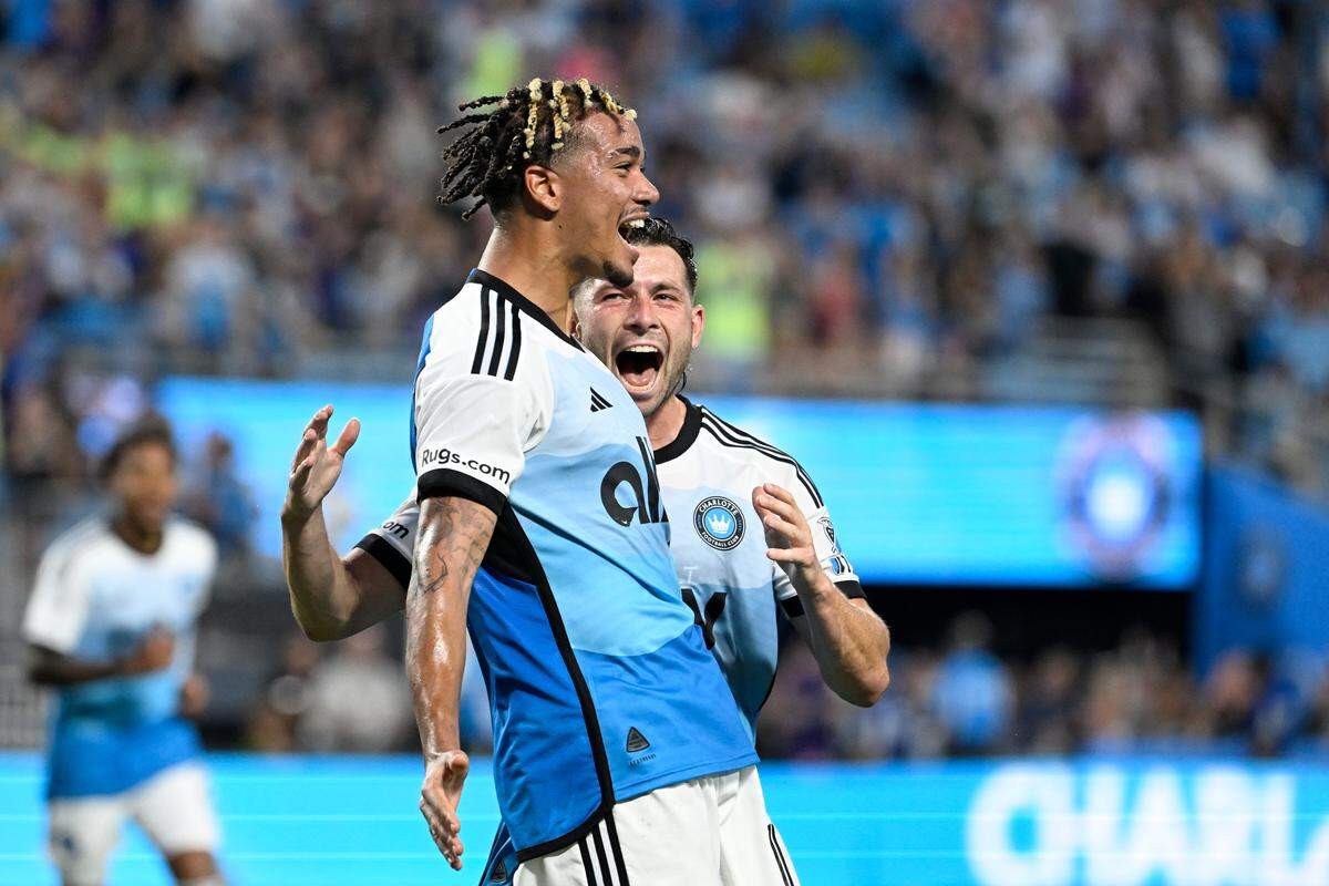 Charlotte FC forward Idan Toklomati (17) celebrates with midfielder Brandt Bronico (13) after scoring a goal in the first half at Bank of America Stadium. 