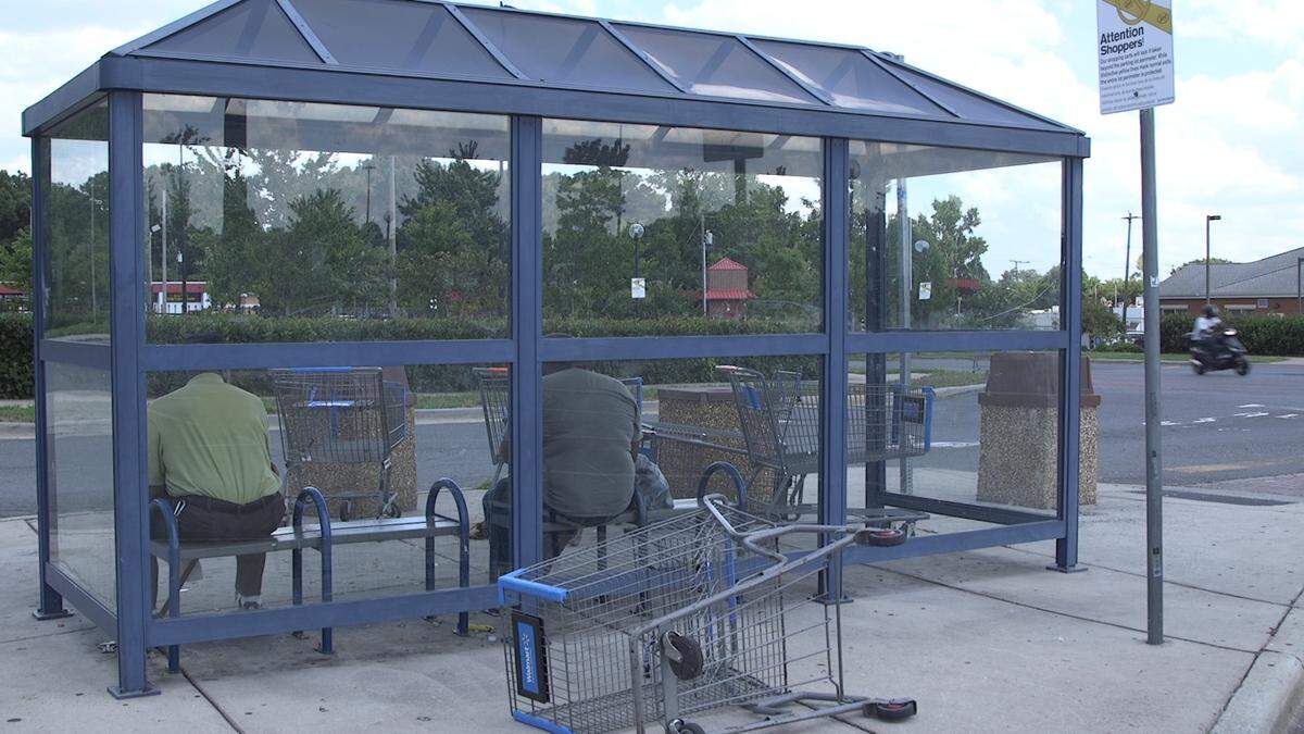 People waiting for the bus in front of Walmart on Wilkinson Avenue.