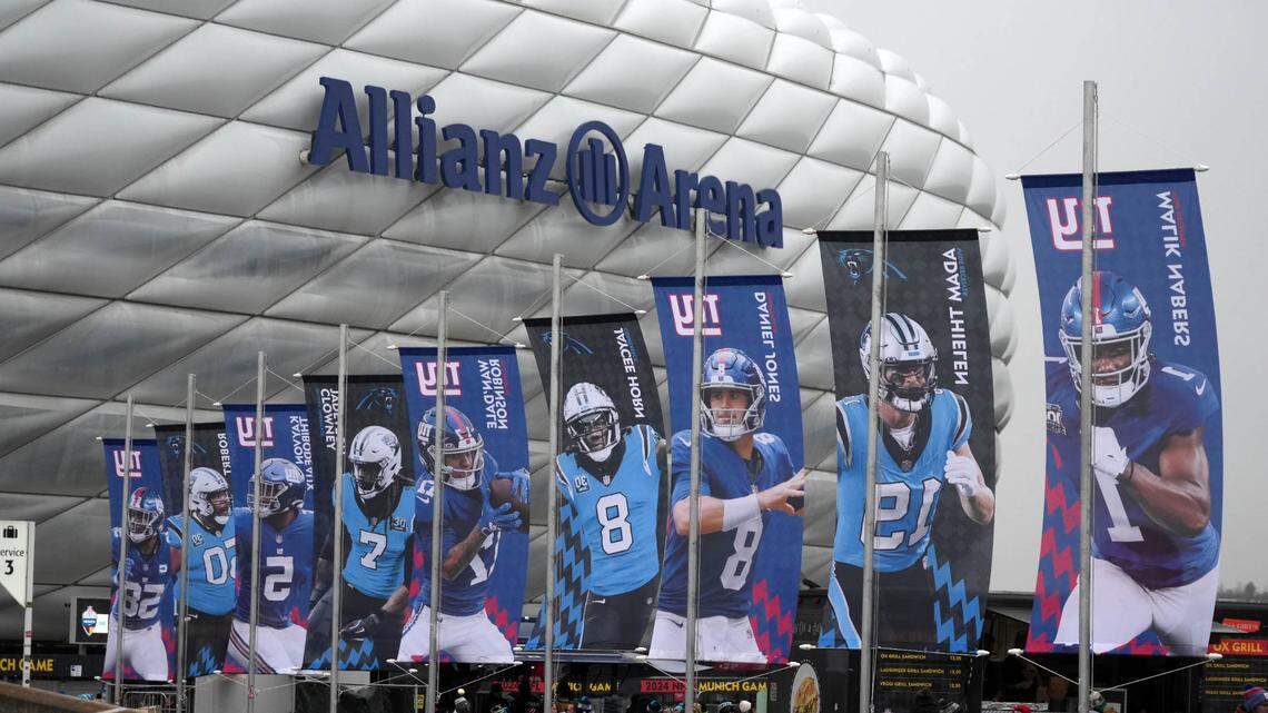Banners of New York Giants and Carolina Panthers players during the 2024 NFL Munich Game at Allianz Arena.