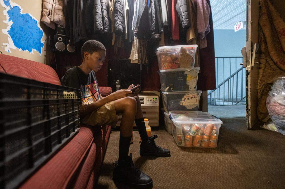 Zion Hall Jr, 14, sits in room 202 of the Southern Comfort Inn on Tuckaseegee Road where he and his mother, Lavora Wilson, 46, have been living for about a year and a half. Alongside a handful of other tenants, they are being relocated as the Southern Comfort Inn closes down. “Anything’s better than this,” Wilson says.