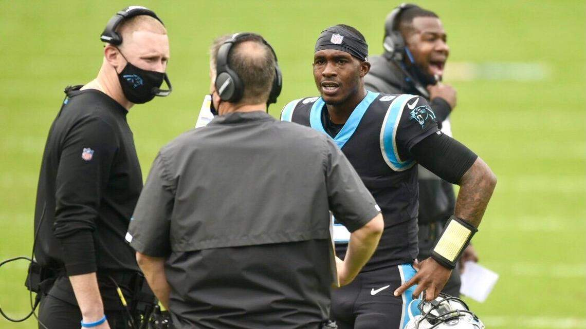 Quarterback PJ Walker listens to Panthers coach Matt Rhule, center, and former offensive coordinator Joe Brady in a game against the Lions last season. Brady was fired on Sunday.