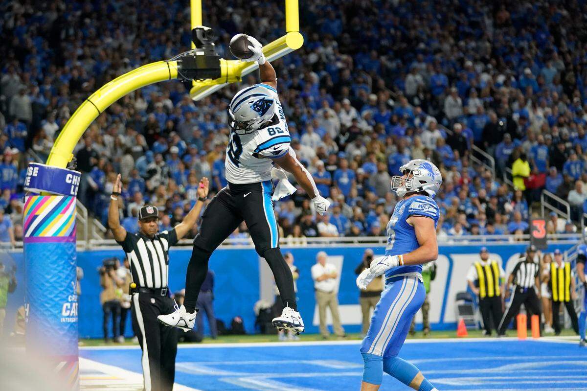 Carolina Panthers tight end Tommy Tremble (82) celebrates his touchdown over Detroit Lions linebacker Jack Campbell (46) in the first half of an NFL football game in Detroit, Sunday, Oct. 8, 2023. (AP Photo/Paul Sancya)