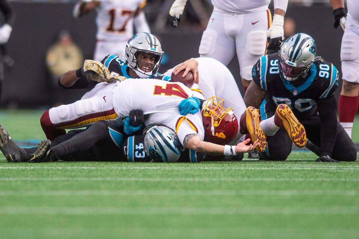 Panthers defensive end Brian Burns, center, reacts after sacking the Washington Football Teams quarterback Taylor Heinicke at Bank of America Stadium on Sunday, November 21, 2021 in Charlotte, NC.