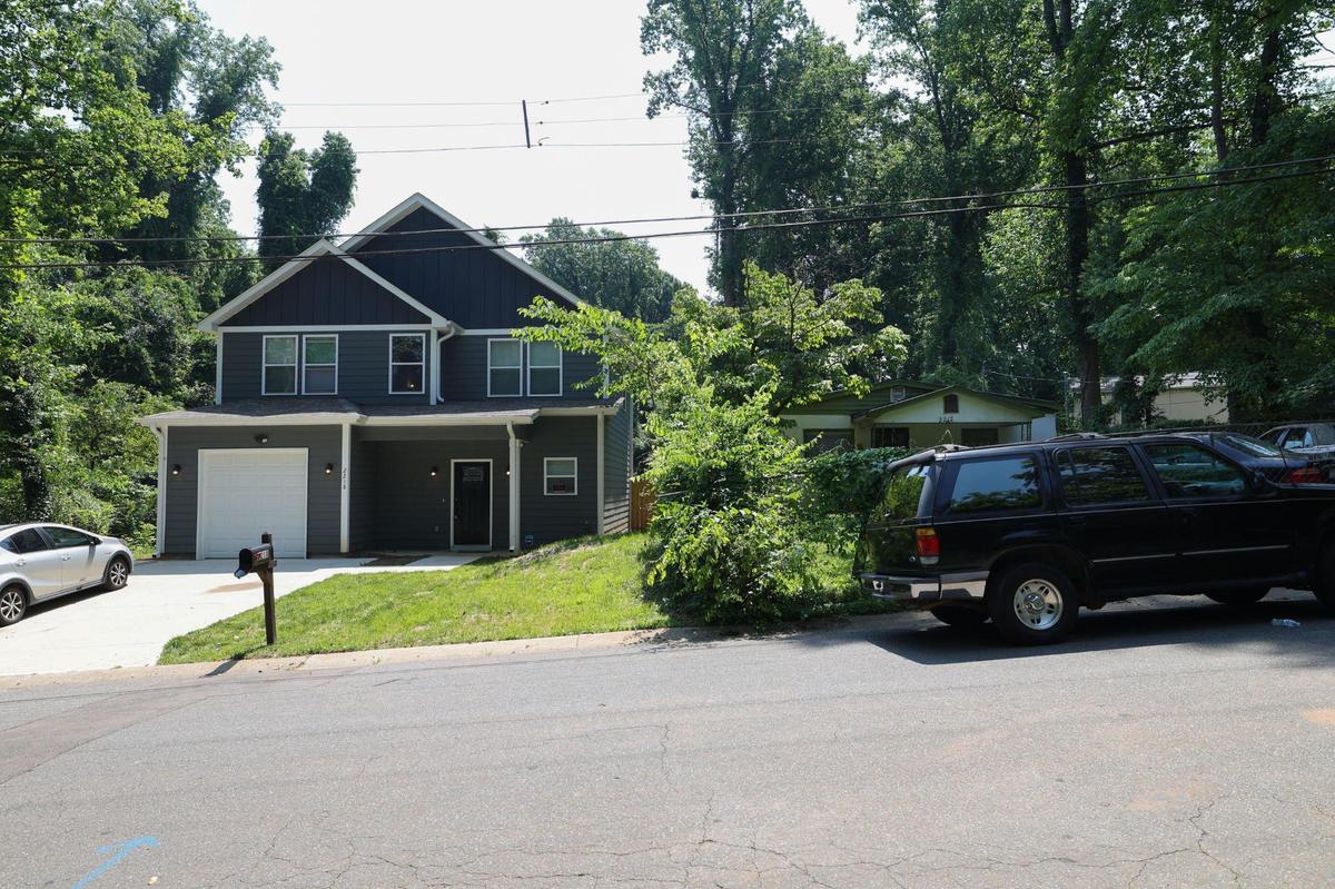 Two houses -- one brand-new and one older -- sit side-by-side on Kennesaw Drive in Lincoln Heights.