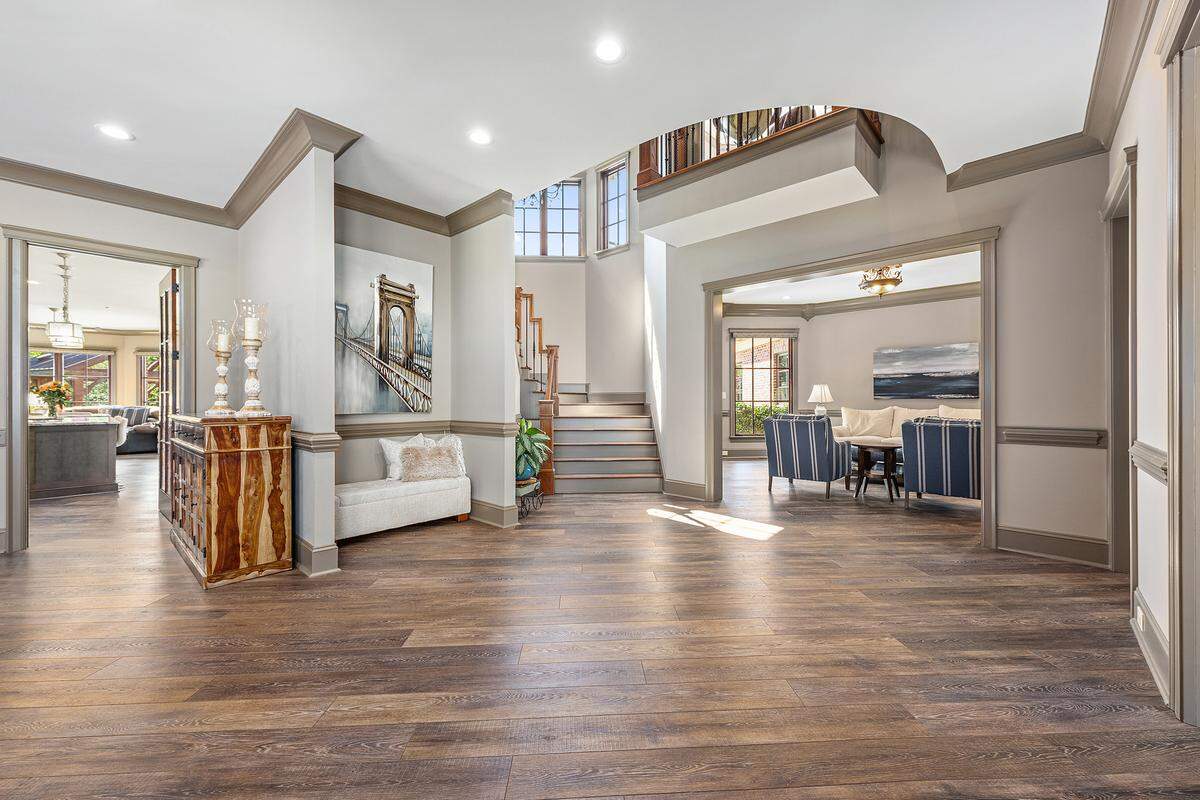 The brick house in Gastonia features a circular driveway, 10-foot ceilings, a pool and outdoor entertaining area with a TV and grill.