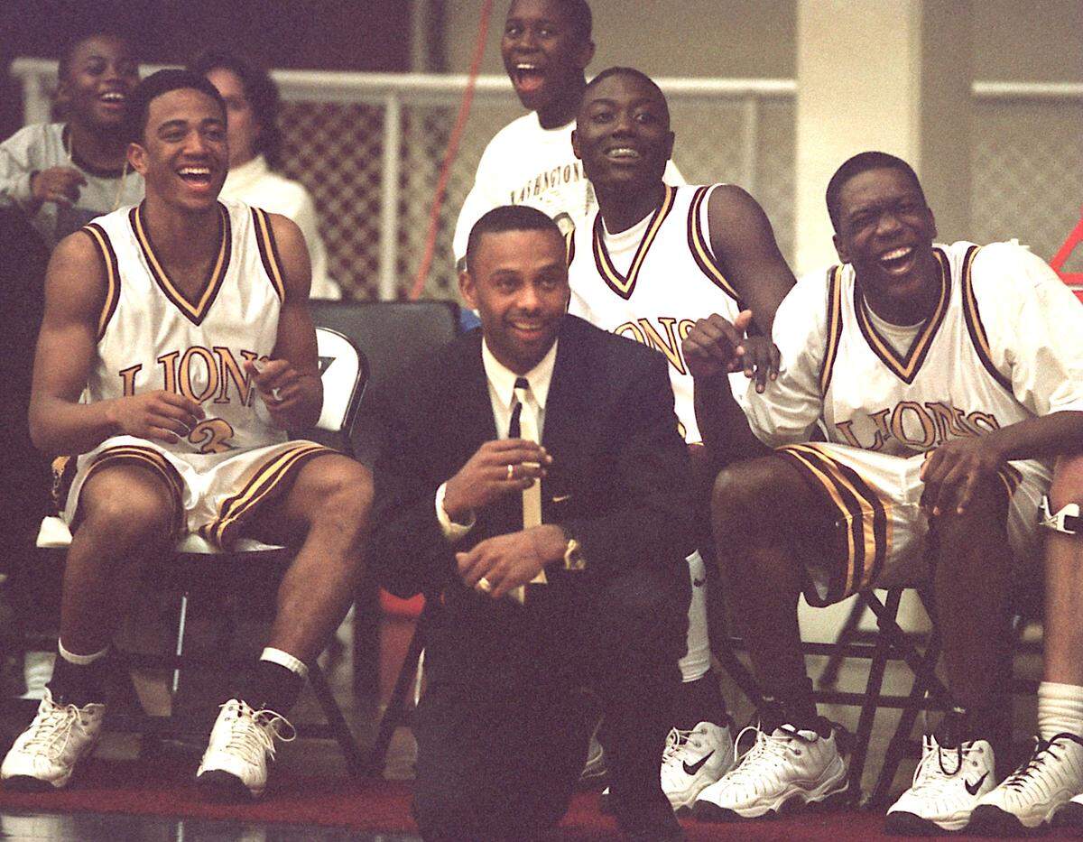 In the 1997-98 season, West Charlotte boys’ basketball coach Gosnell White, center, led his team to the N.C. 4A state semifinals with, from left, Marcus Oliver, Dom Townes and Dell Douglas.