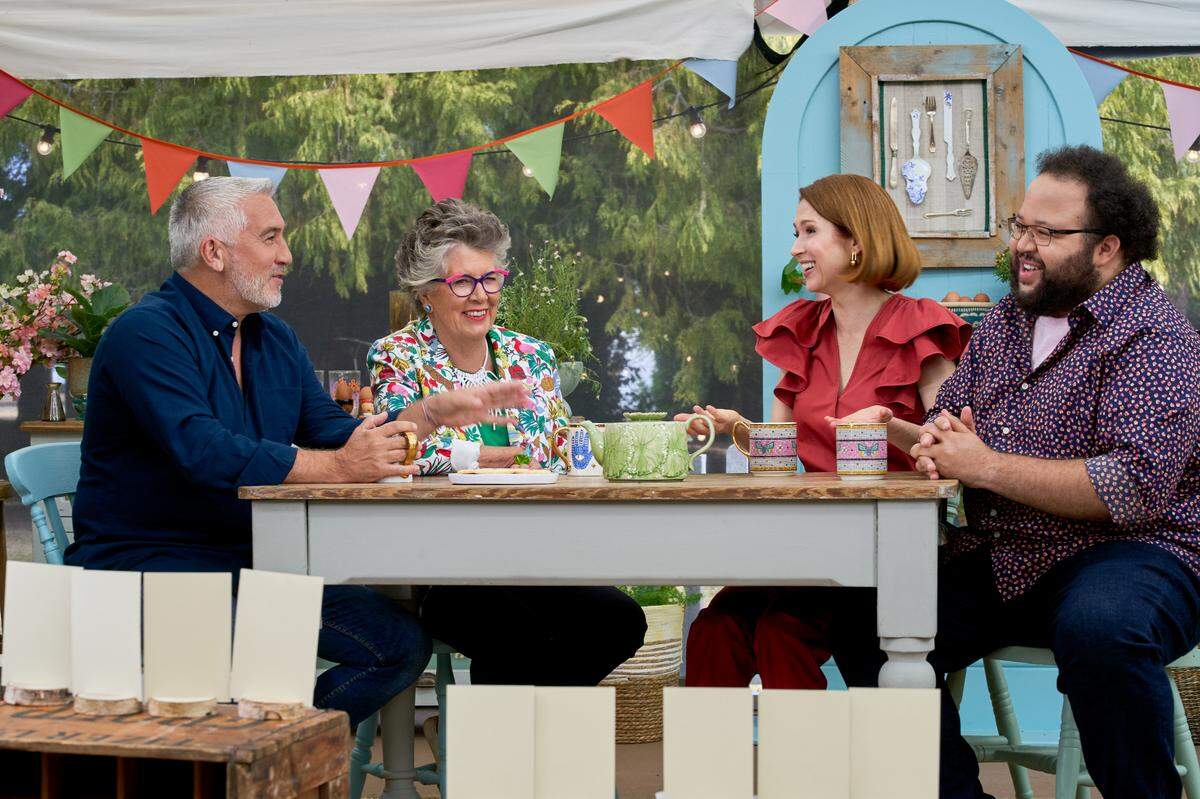 “The Great American Baking Show” is judged by Paul Hollywood and Prue Leith, and hosted by Ellie Kemper and Zach Cherry (left to right).