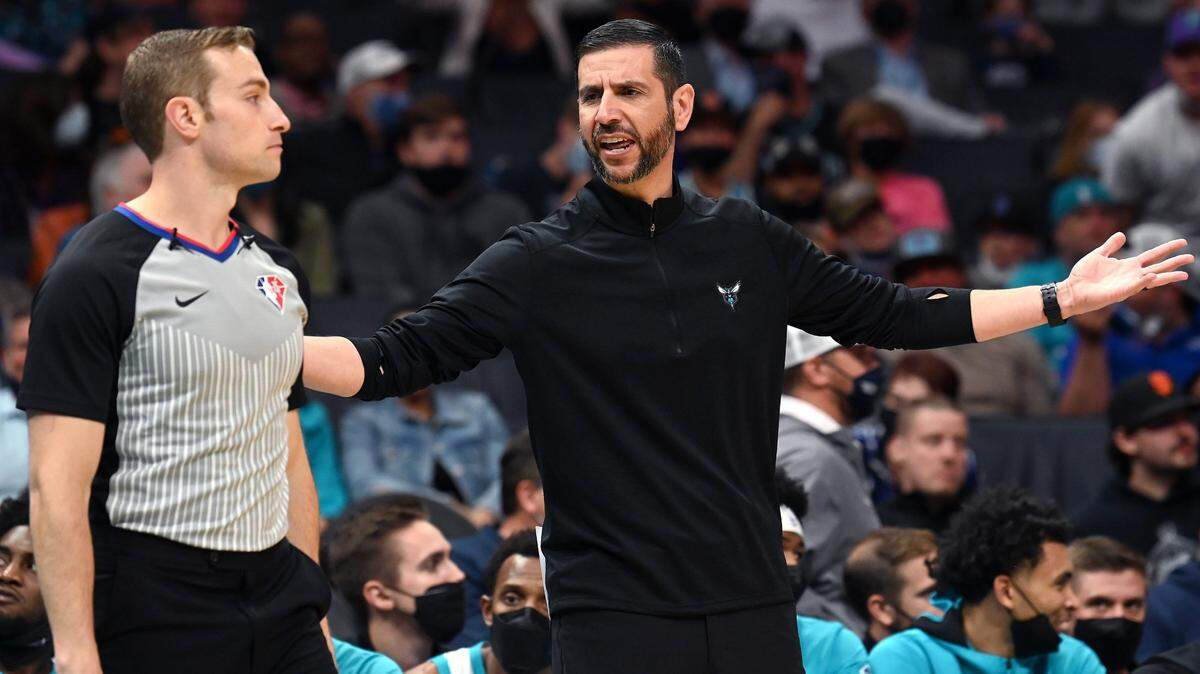 Former Charlotte Hornets head coach James Borrego, right, questions a non-call with umpire Brandon Schwab, left, during second half action against the Cleveland Cavaliers at Spectrum Center in Charlotte, NC on Monday, November 1, 2021.