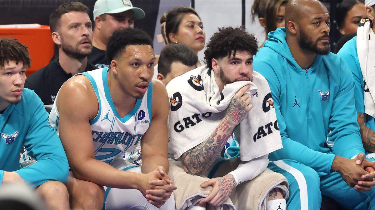 Charlotte Hornets guard LaMelo Ball, center, sits on the bench during first-quarter action against the Orlando Magic at Kia Center in Orlando on Friday. Orlando drubbed the Hornets, 121-90, ending Charlotte’s season.