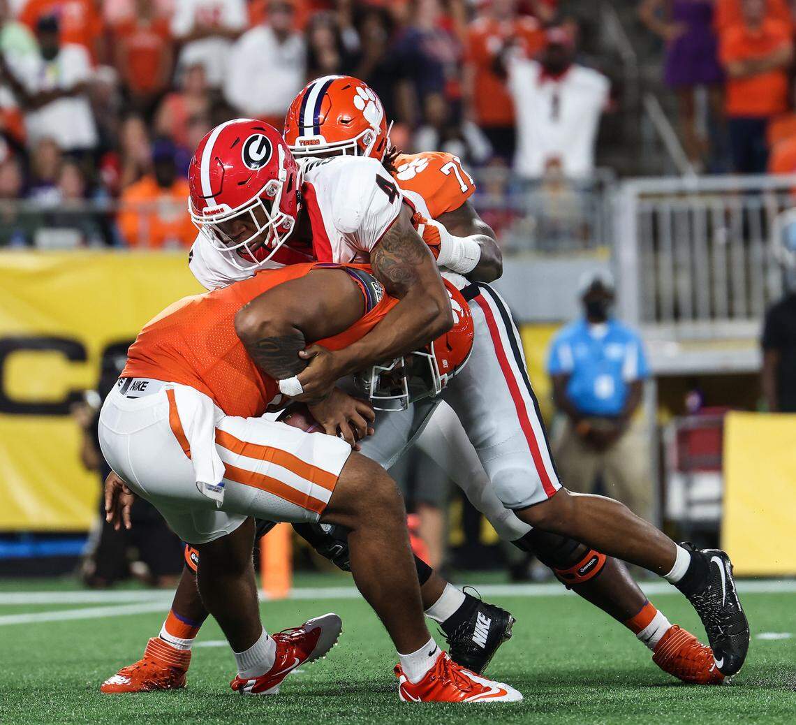 Clemson’s QB D.J. Uiagaleleiis, left, is sacked by Georgia’s Nolan Smith during the Duke’s Mayo Classic at Bank of America Stadium in Charlotte Saturday. Georgia won, 10-3.