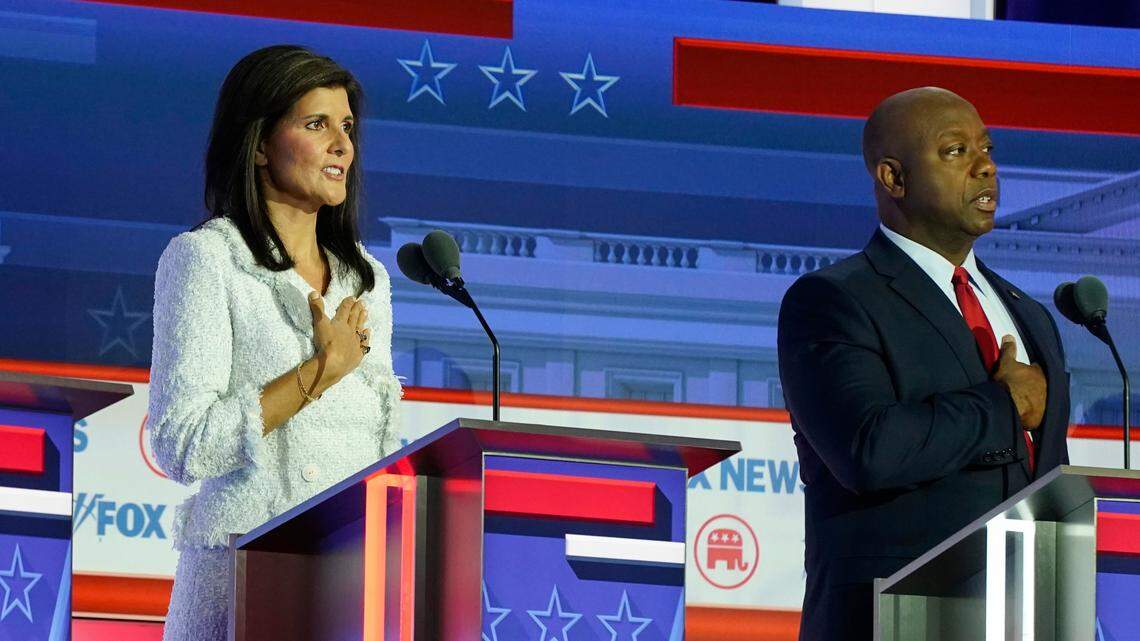 Republican presidential candidates former U.N. Ambassador Nikki Haley and Sen. Tim Scott, R-S.C., stand on stage at the Republican presidential primary debate Aug. 23, 2023 in Milwaukee.