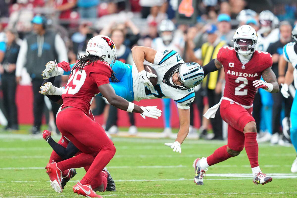 Arizona Cardinals safety Jalen Thompson (34) tackles Carolina Panthers wide receiver Brycen Tremayne (87) during Sunday’s fourth quarter at State Farm Stadium in Glendale, Ariz. Tremayne had a nice day, with 48 yards receiving and the game’s best one-handed catch.