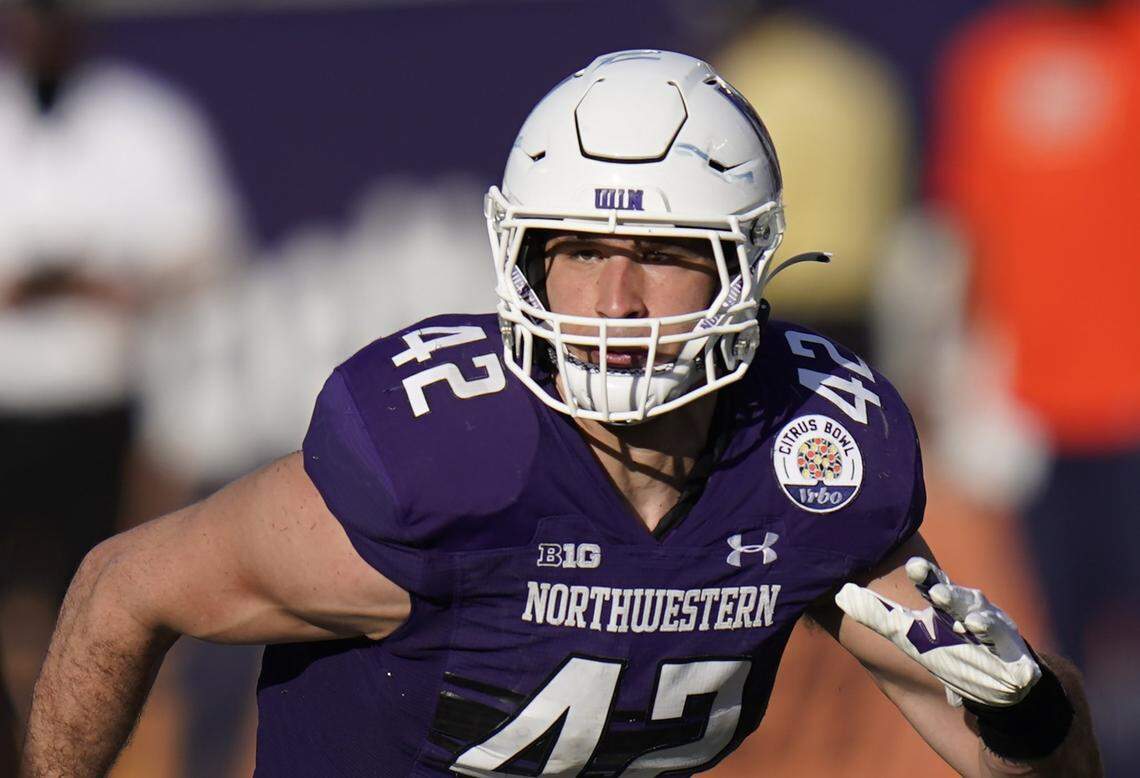FILE - In this Jan. 1, 2021, file photo, former Northwestern linebacker Paddy Fisher covers a play against Auburn during the second half of the Citrus Bowl NCAA college football game in Orlando, Fla. Fisher has been named the winner of the 17th Annual Lott IMPACT Trophy. The announcement came Sunday, Feb. 21, 2021, at the Pacific Club in Newport Beach, CA. at the Lott IMPACT Trophy Annual Award Show. (AP Photo/John Raoux, File)