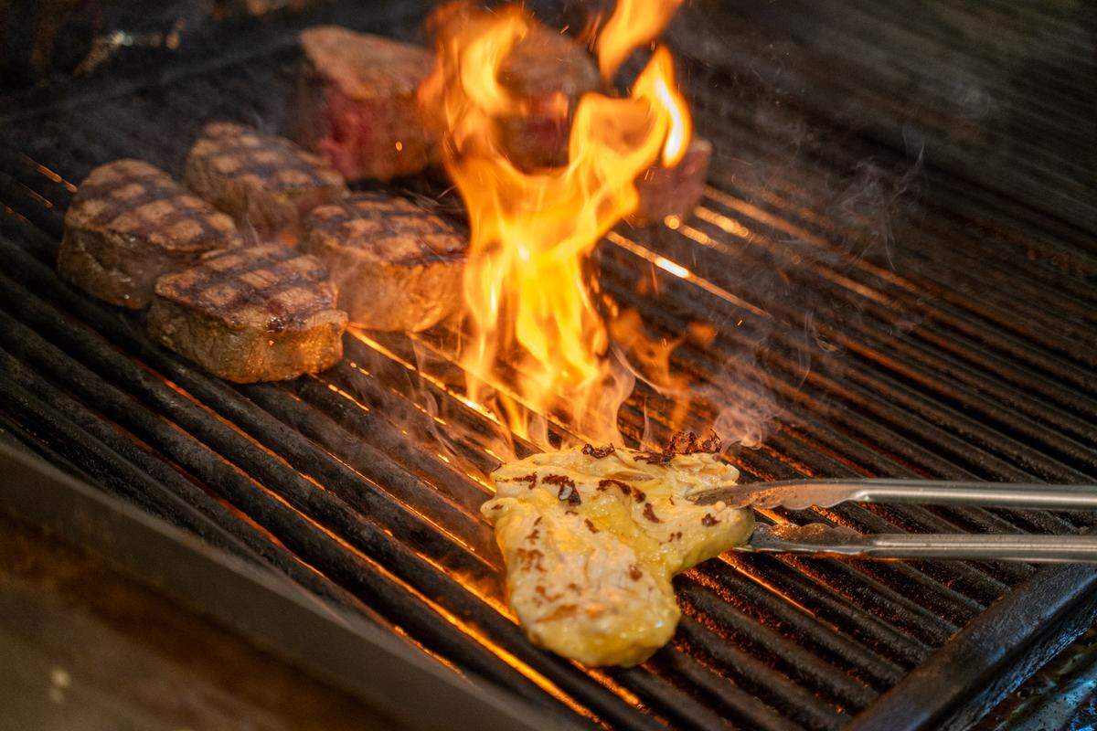 Chicken and filets on the grill at Beef ‘N Bottle.
